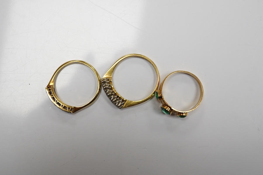 A group of three rings and a gold toothpick